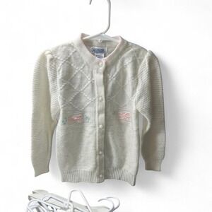 Adorable baby pink and white knit cardigan with bows and pink ribbon details